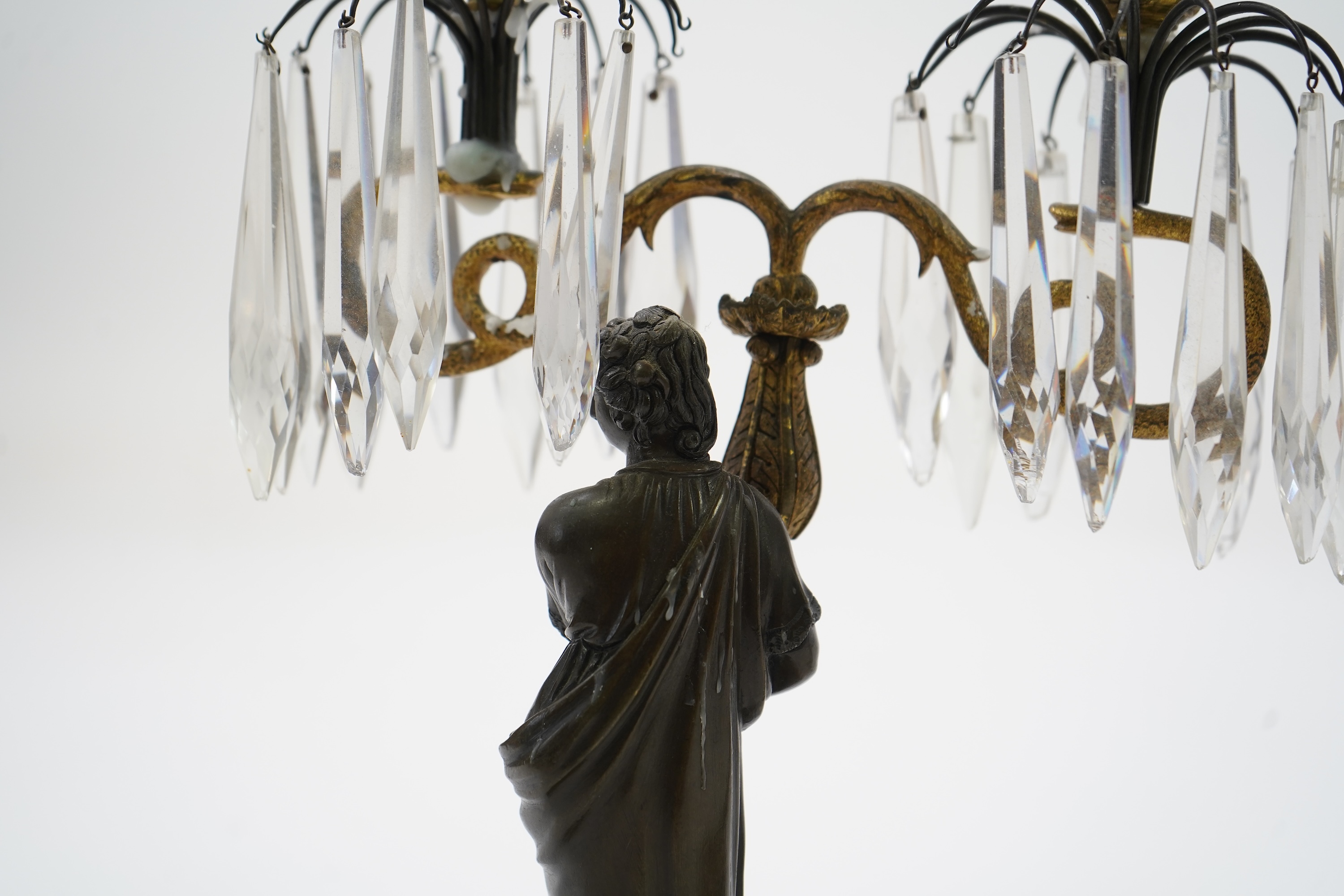 After Mathurin Moreau. A pair of mid 19th century bronze and gilt bronze two branch candelabra